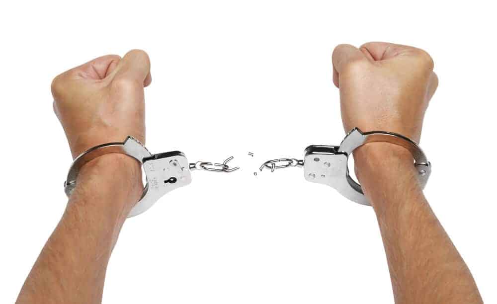 hands and breaking handcuffs shutterstock 58240561 1